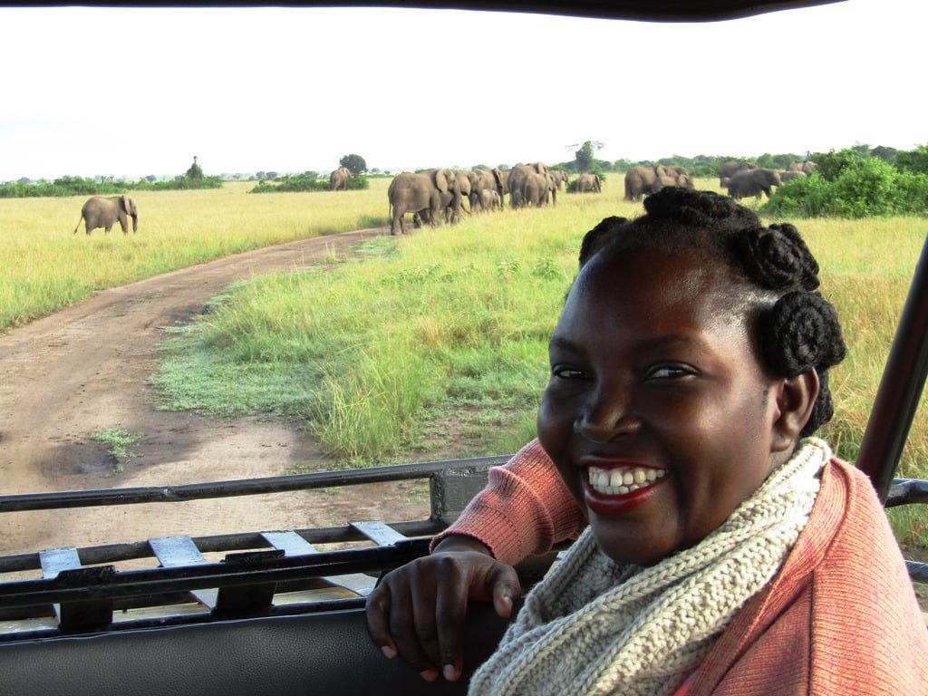 Irene Nalwoga, CEO Women Tour Uganda, with elephants in the background