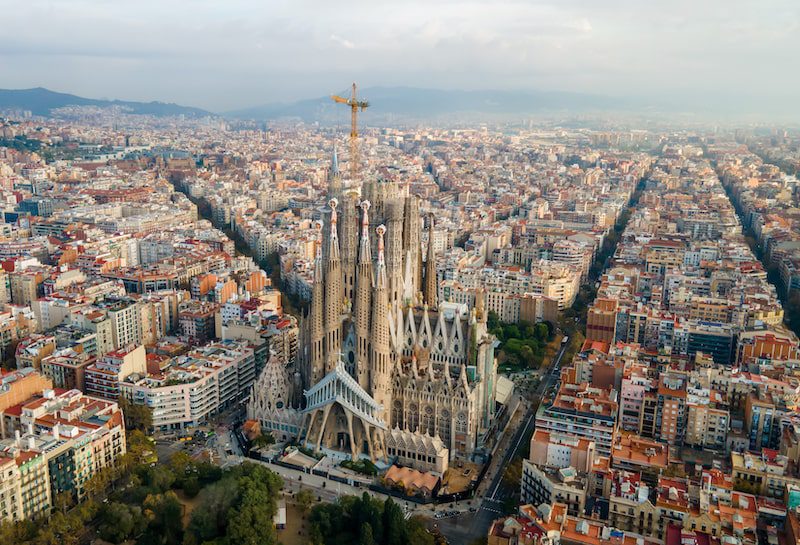 Aerial drone view of Barcelona, Spain. Blocks with multiple buildings, roads, Sagrada Familia
