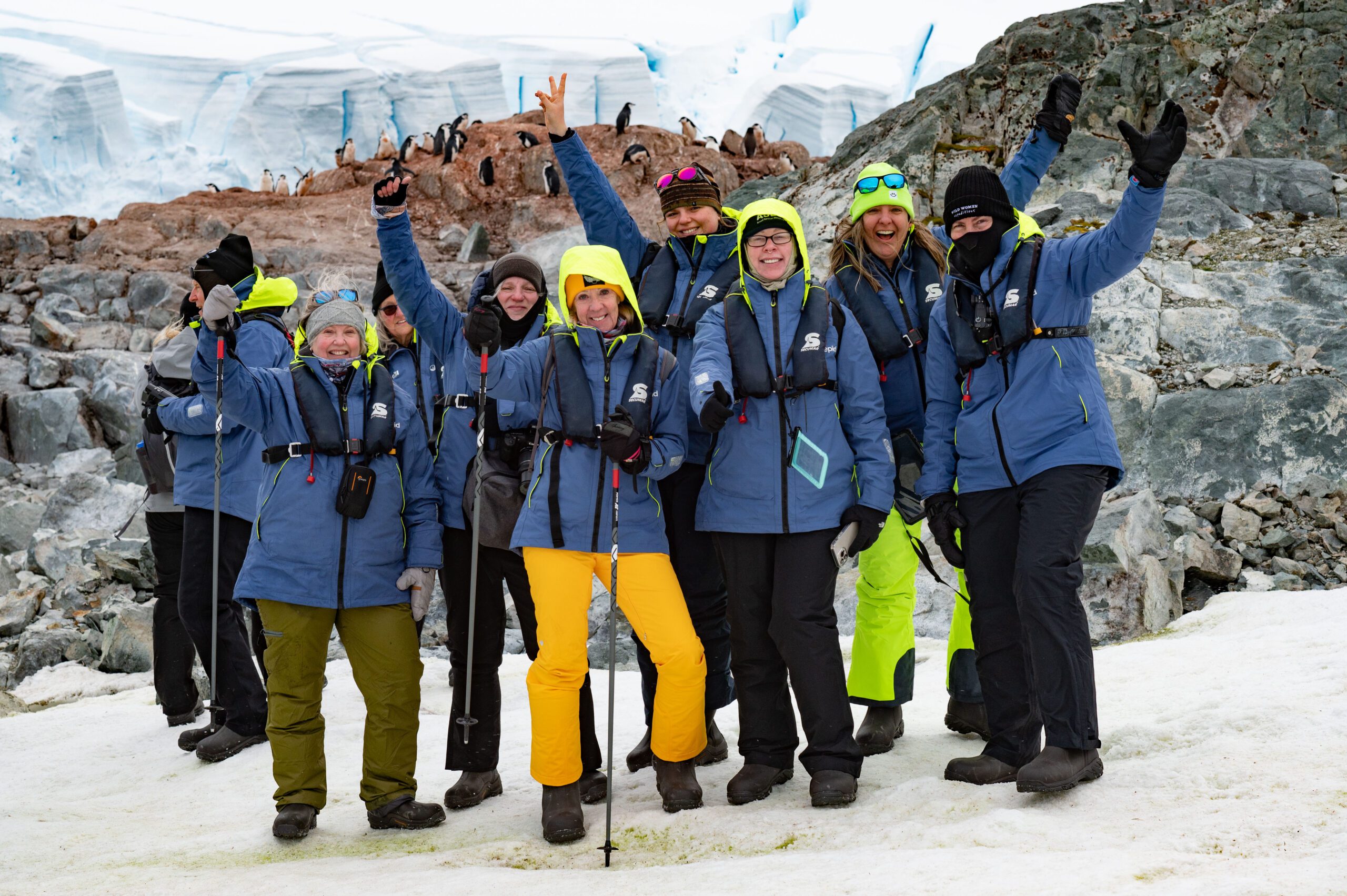 A group of tour participants standing amidst the stunning landscapes of the Falklands, South Georgia, and Antarctica.