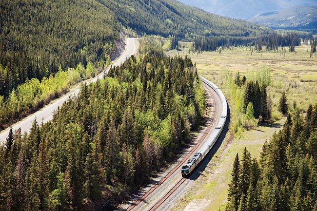 An aerial view of a Via Rail train as it passes through a low valley - the Canadian Prestige: Eastbound - Canada Rail Trips