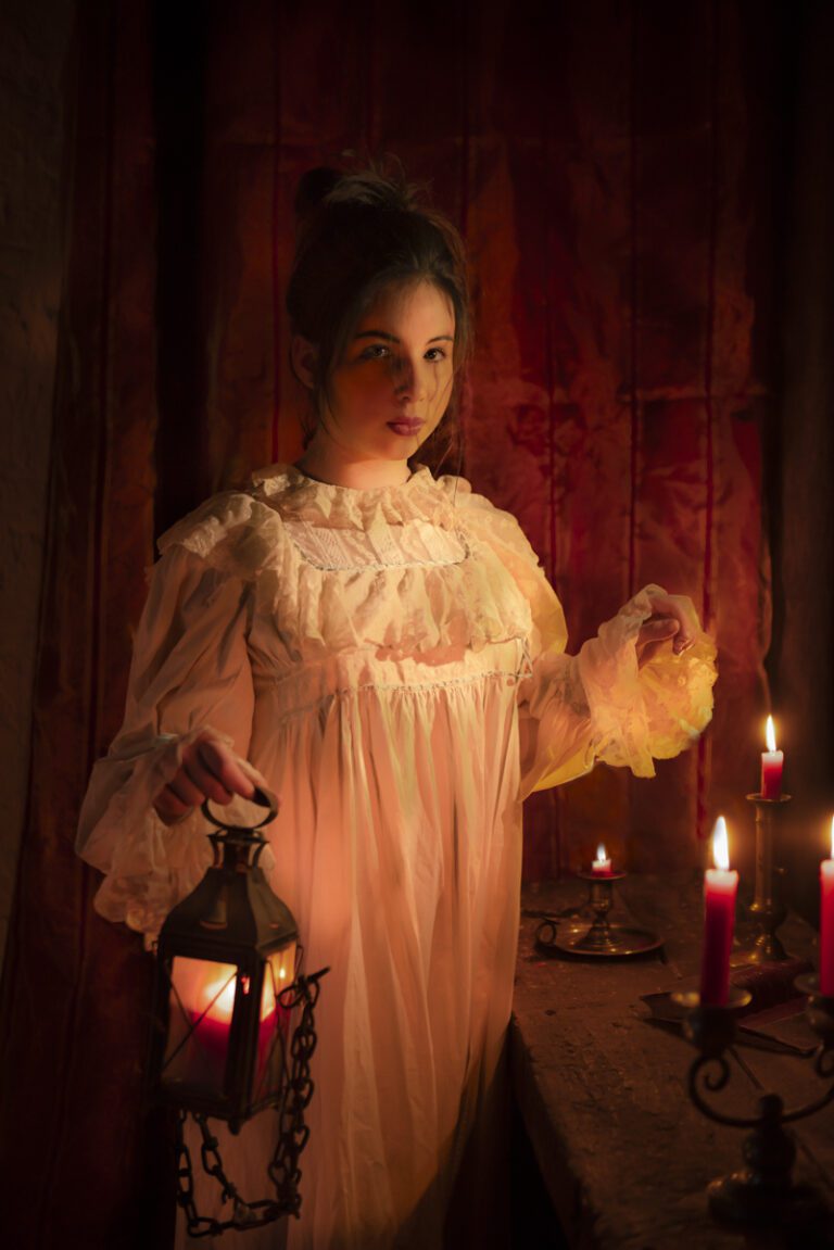A detailed photo of a historically dressed woman in a nightgown holding a lantern - Fine Art Portraiture Workshop in Provence - Provence Lifestyle and Photography Tours