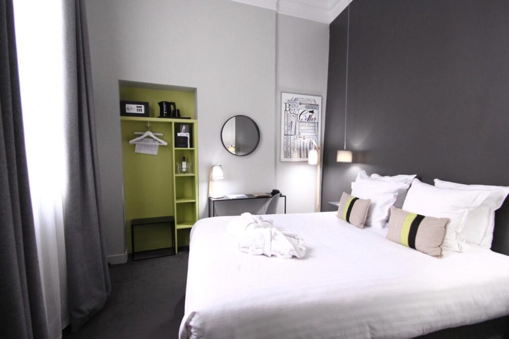 A stylish and simple room with a queen bed at the Hotel du Tourny in Bordeaux, France. Recommended by readers of the Women's Travel Directory.