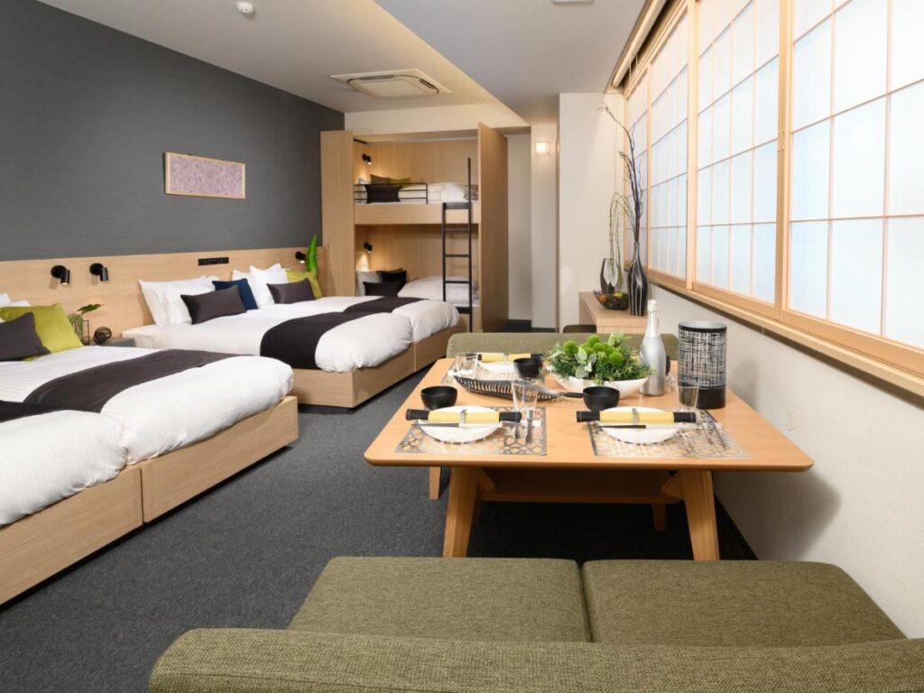 A family-sized apartment with two full beds, bunk beds and a table for four at the Mimaru Tokyo Ueno North, Japan