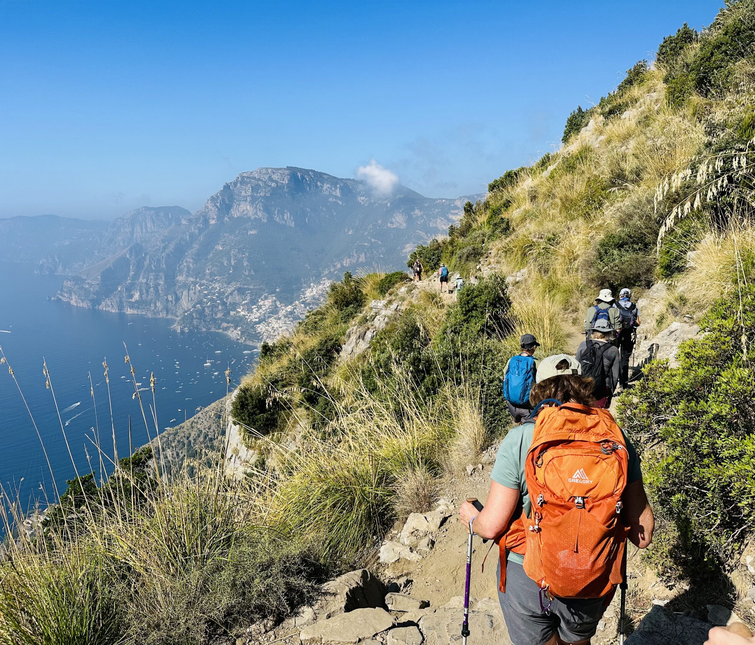 Women walk in line along a coastal path overlooking the sea - Sicily and the Amalfi Coast - Adventures in Good Company