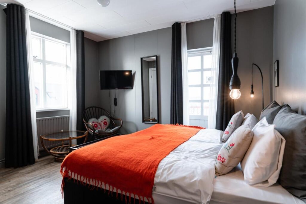 A modern, comfortable looking hotel room with a double bed and simple amenities - Hotel Leifur Eiriksson, Reykjavik Iceland