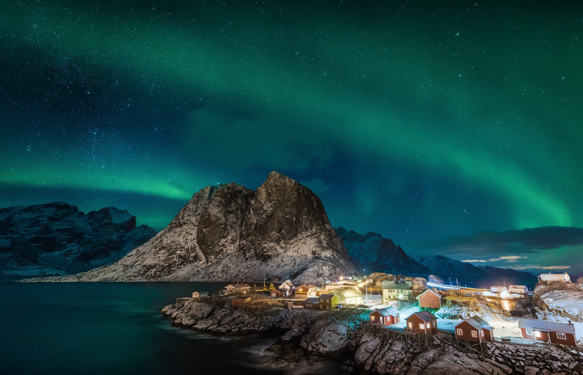 The Northern Lights shine over the village of Lofoten Hamnoy - Hurtigruten Norway - Follow the Northern Lights North