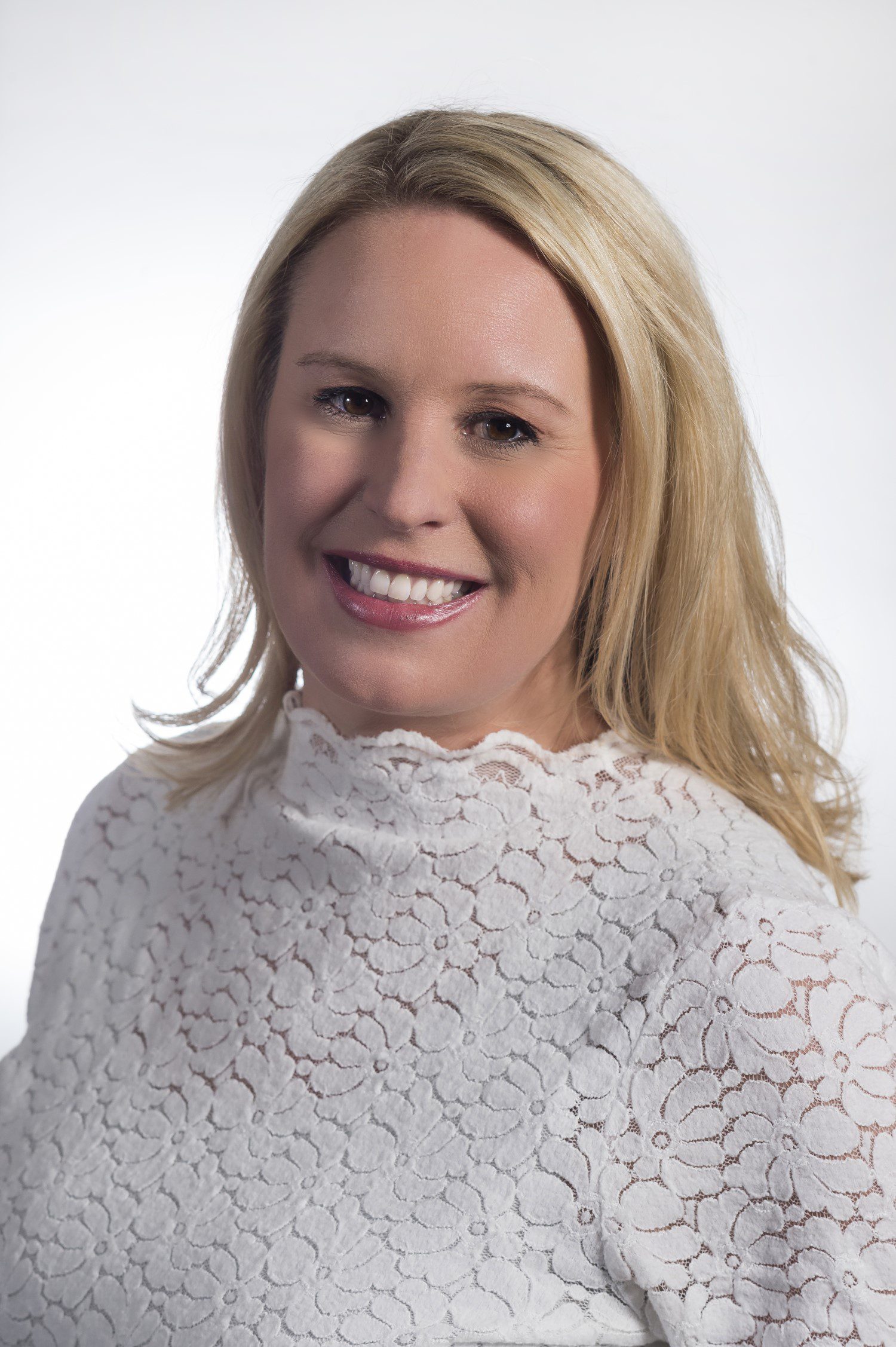 A headshot of Collette Travel CEO and President Jaclyn Leibl-Cote wearing a lace blouse.