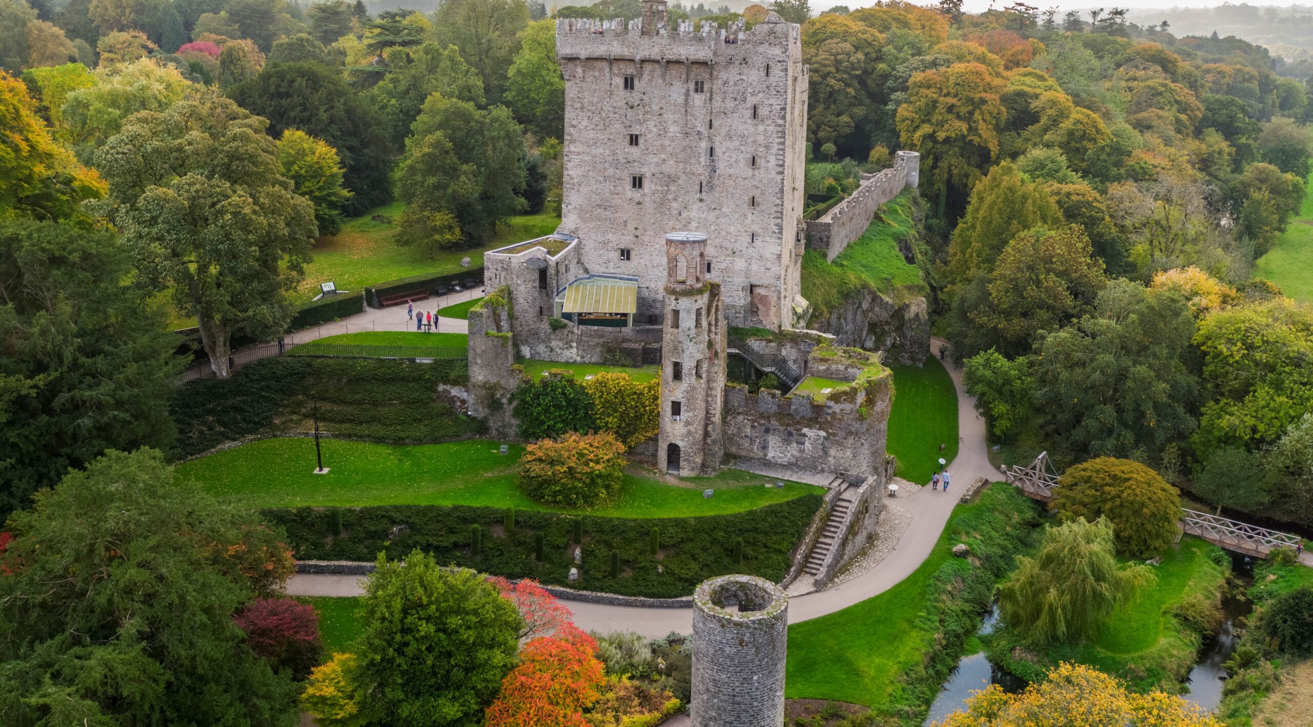 View of an autumn day, trees changing color and the view of Blarney Castle - Irish Roads to Cuisine and Culture - Brendan Vacations.