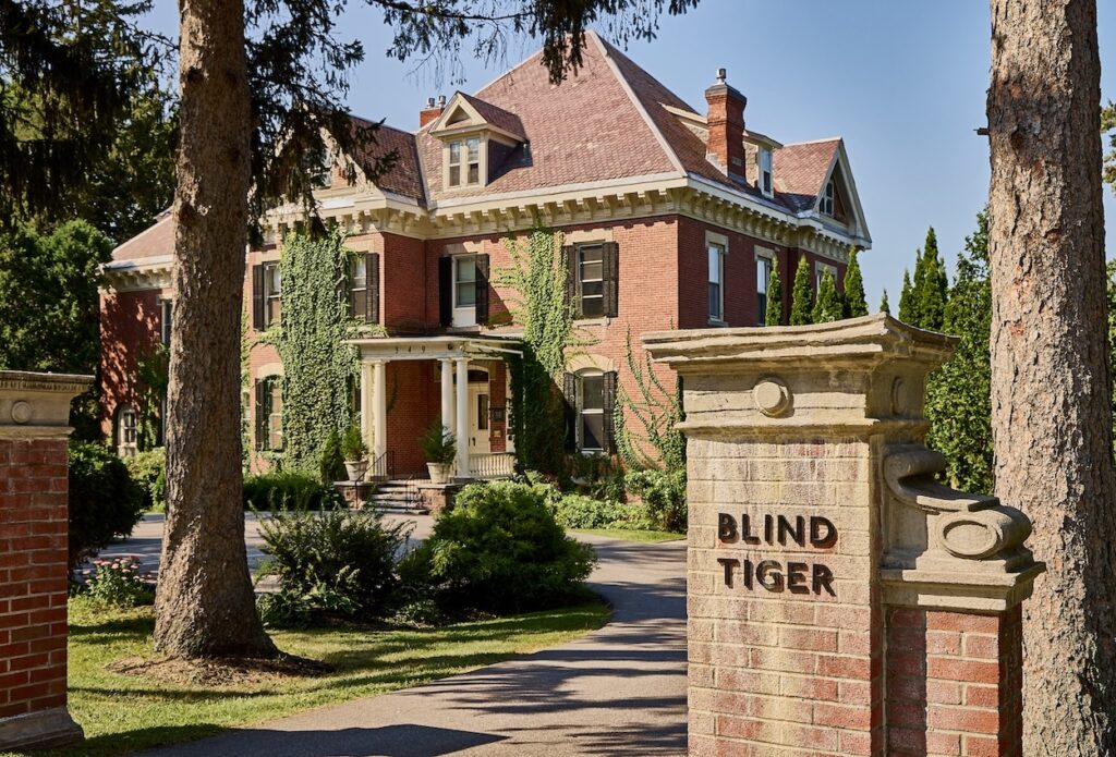 The stone exterior of the stately Blind Tiger hotel in Burlington, part of the Lark Hotels family.