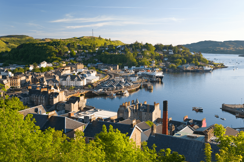 Panoramic vista of Oban's picturesque harbor, nestled amidst rugged coastal beauty - Scenic Scotland a Women-Only Tour - Brendan Vacation