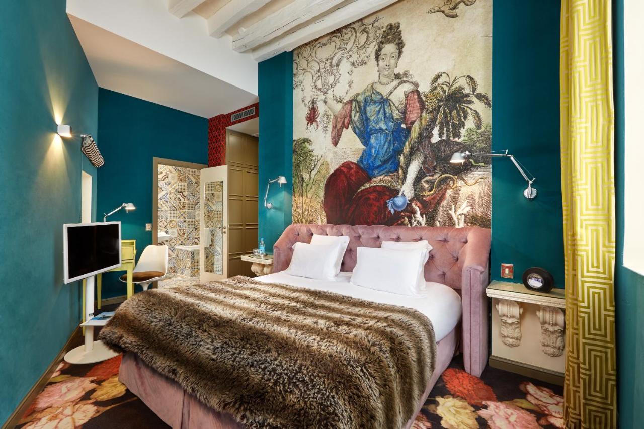 A funky superior double room at the Hotel du Petit Moulin in Paris, France, recommended as a safe place for women to stay by JourneyWoman readers.