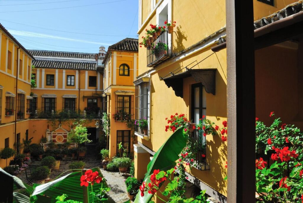 Hotel las Casas de la Juderia in Seville Spain is brightly-coloured, historic accommodation recommended by JourneyWoman readers as a safe place for women to stay.