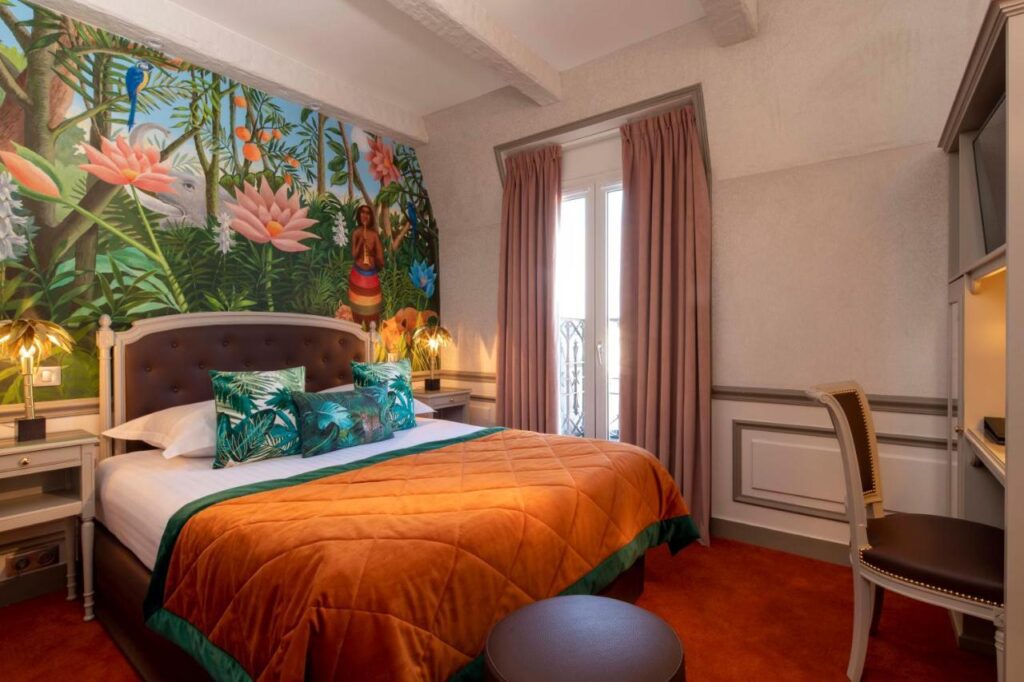 A classic double room at the Hotel and Spa St Jacques in Paris, France, with jungle wallpaper, recommended by a JourneyWoman reader as a safe place to stay for women.