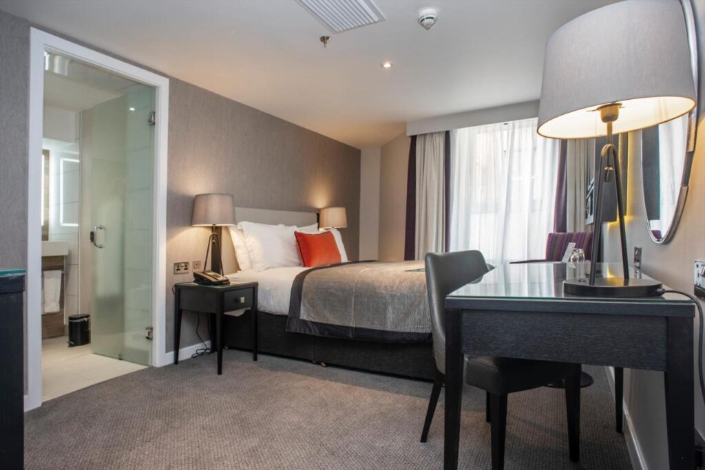 A single room with double bed and large, accessible bathroom at Ten Hill Place in Edinburgh, Scotland, recommended by JourneyWoman readers as a safe place to stay.