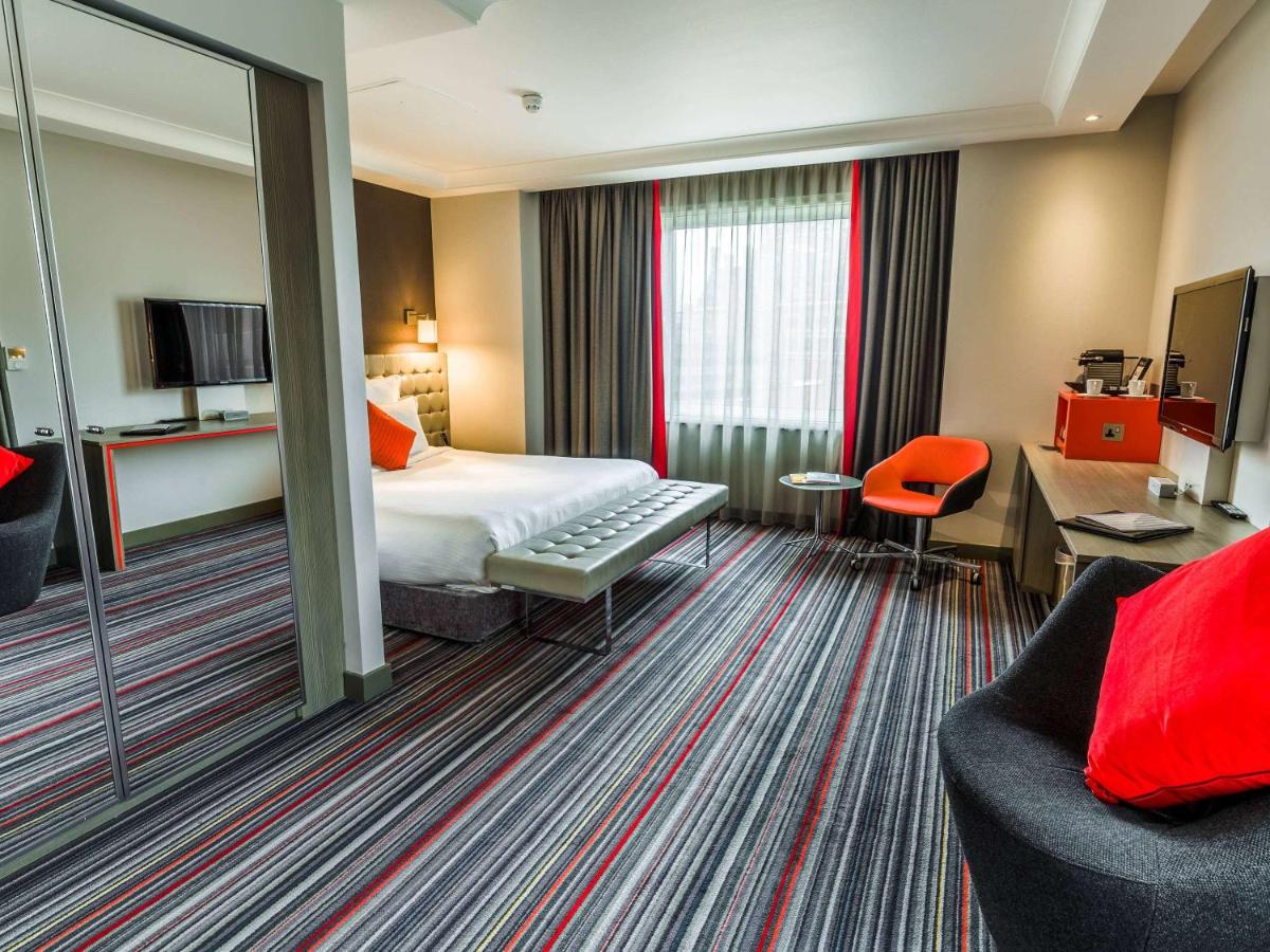 The interior of a standard room with a double bed at the Pullman St Pancras hotel in London, England. Recommended by JourneyWoman readers as a safe place for women to stay