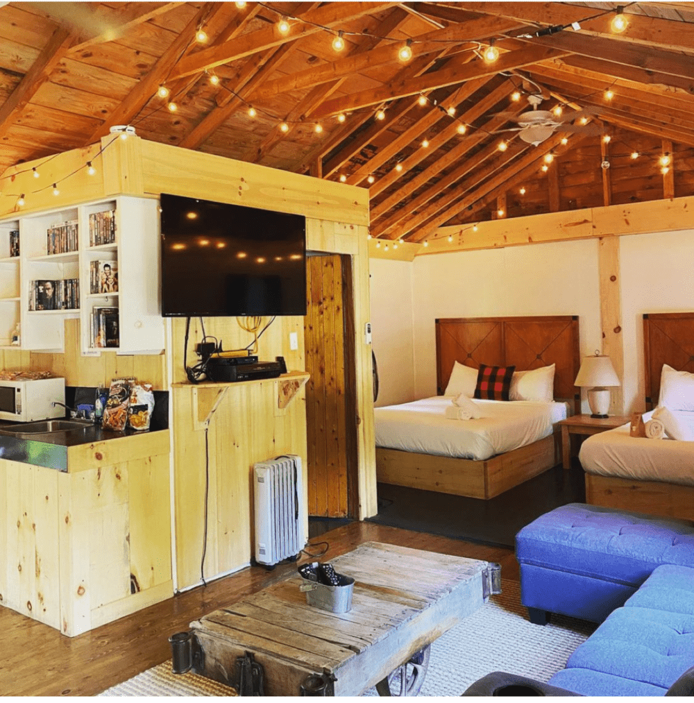 Interior of a bunkie/cabin with double beds at the Muskoka Beer Spa in Torrence, Ontario, recommended by JourneyWoman as a safe place for women to stay.
