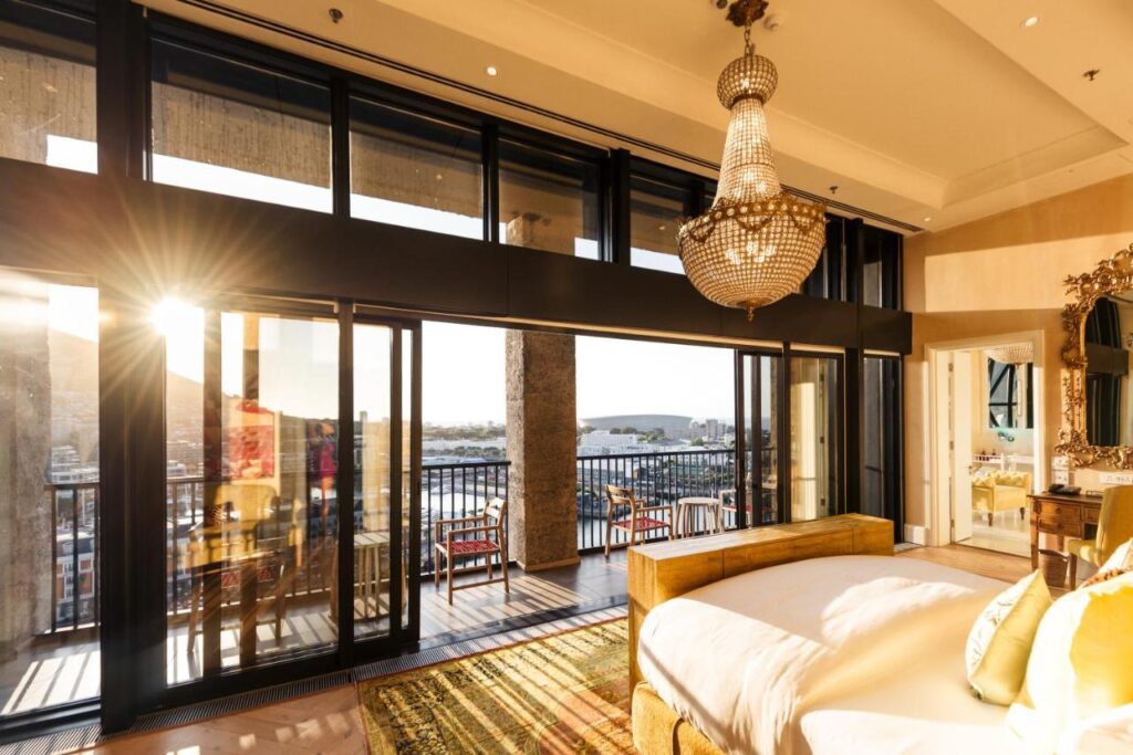 An opulent room with a wall of windows overlooking the Waterfront, part of the Silo Hotel in Cape Town, South Africa, recommended by a JourneyWoman reader as a safe place for women to stay.