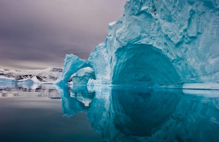 Giant icebergs along the coastline of East Greenland before sunrise. Shutterstrocks