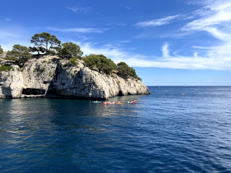 A scenic boat ride through the stunning Calanques of Marseille, experienced during the Mediterranean Coastal Journey tour, showcasing dramatic cliffs, turquoise waters, and hidden coves.