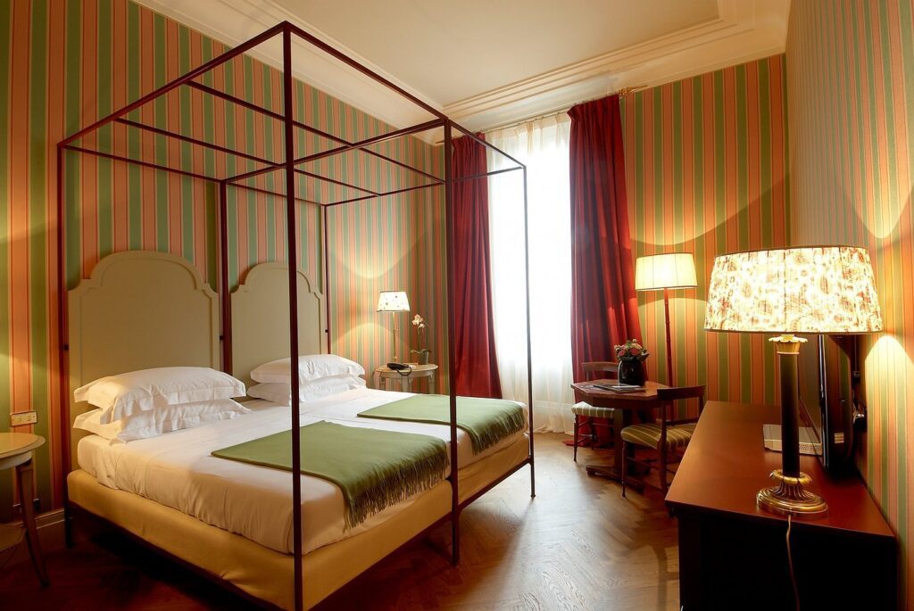 A modern and simply designed double bed suite at Antica Torre hotel in Florence, Italy, recommended by JourneyWoman readers as a safe place for women to stay.