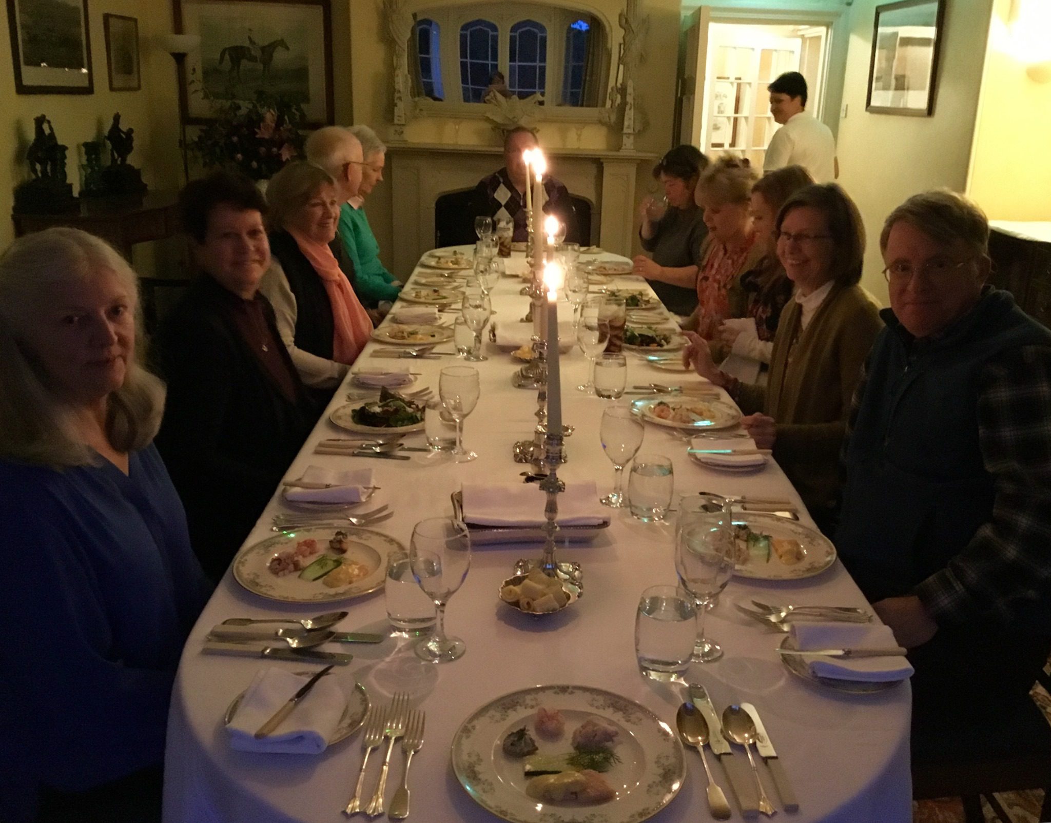 Guests sit at a long table, part of the Autumn in Hidden Ireland tour hosted by Ann Quinlan of Spiral Journeys