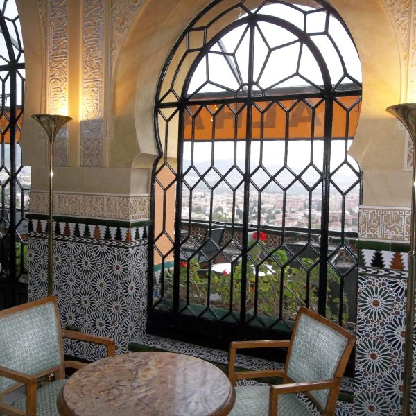 Extravagant windows in the seating area of the Alhambra Palace Hotel in Granada Spain, recommended by a JourneyWoman reader as a safe place for women to stay.
