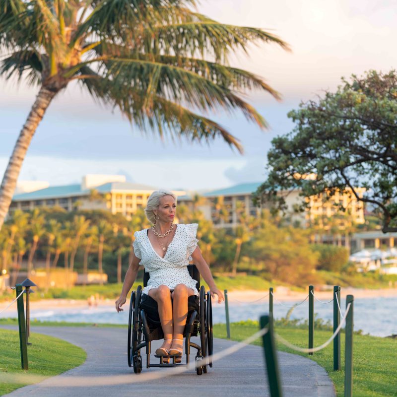 Confident woman in a wheelchair on vacation