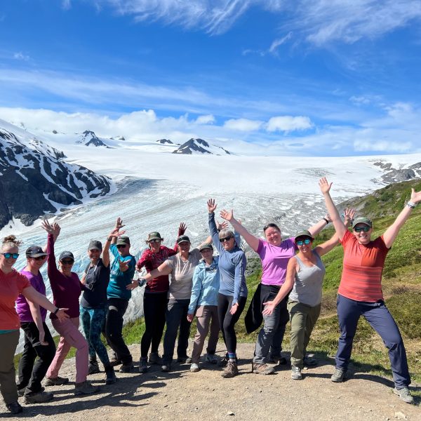 Group of women joyfully celebrating at the summit after completing a scenic hike - Alaska Women’s Adventure Hiking & Multi-Sport Tour