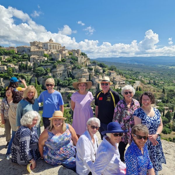 A group of women pose together for a photo in the South of France - Provence Excited about Food Tour - Absolutely Southern France