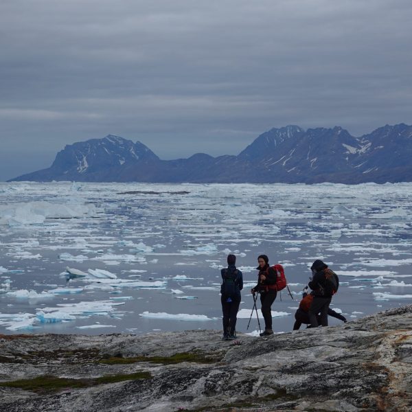 Woman trekking across a stunning glacier - East Greenland Adventure Wild Arctic Trails & Tales