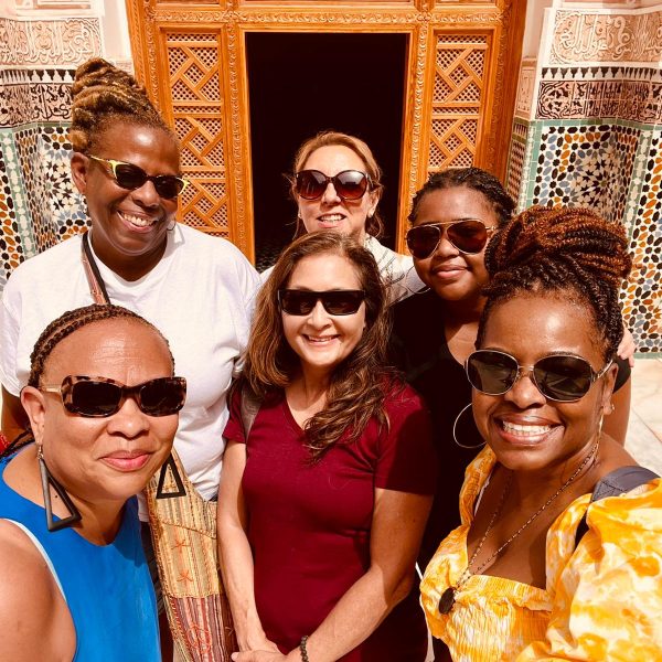 A group of women exploring the vibrant Majorelle Gardens, surrounded by lush greenery and iconic blue architecture - Morocco's Golden Triangle: Marrakech, Agafay & Essaouira