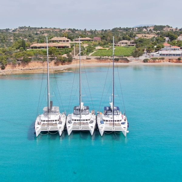 Three catamaran ships connected on the beautiful blue ocean near Greece - Sailing Greece - Joyride Charters