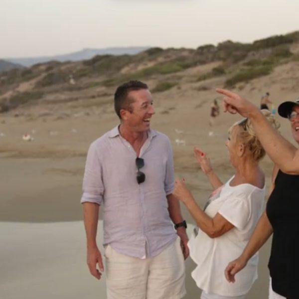 A group of people is enjoying a moment at the serene Akmas beach.