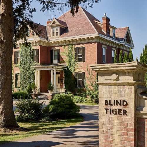 The stone exterior of the stately Blind Tiger hotel in Burlington, part of the Lark Hotels family.