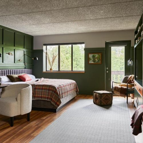 A hunting-inspired with double bed at the Hunter Lodge, a Bluebird by Lark hotel in Hunter, New York, a safe place for women to stay.