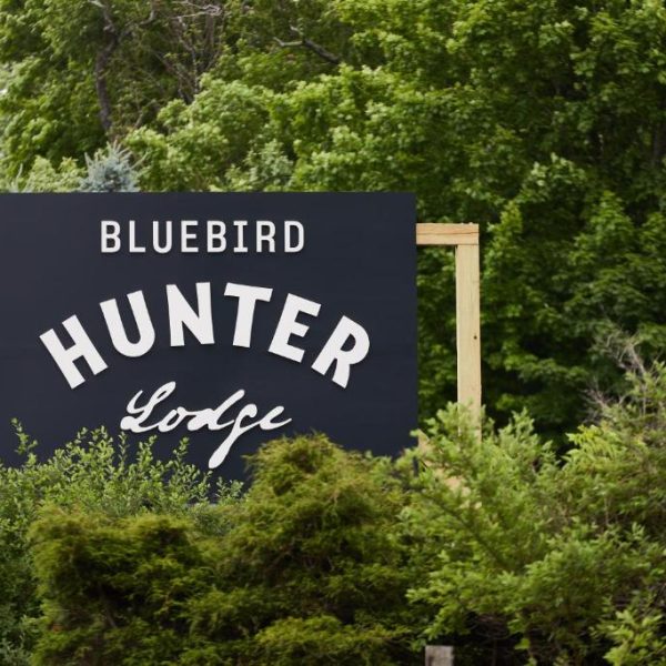 The sign for Hunter Lodge, a Bluebird by Lark hotel in Hunter, New York, a safe place for women to stay.