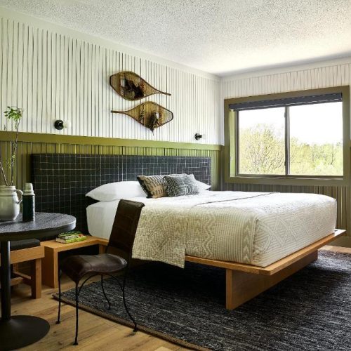 Modern double bed room at the Bluebird Sunapee hotel in New Hampshire, a safe place for women to stay.