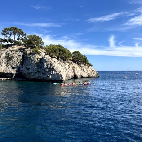 A scenic boat ride through the stunning Calanques of Marseille, experienced during the Mediterranean Coastal Journey tour, showcasing dramatic cliffs, turquoise waters, and hidden coves.