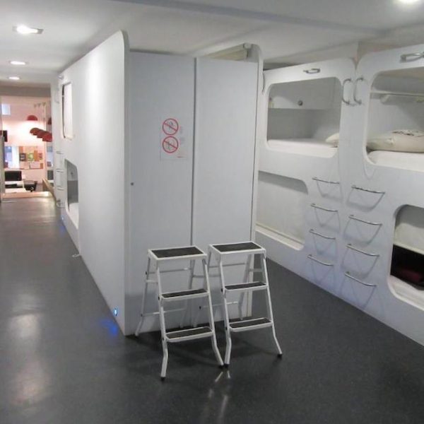 The sleek, white sleeping pods of the Casa Ibarrola hostel in Pamploma, Spain, recommended as a safe place for women to stay by a JourneyWoman reader.