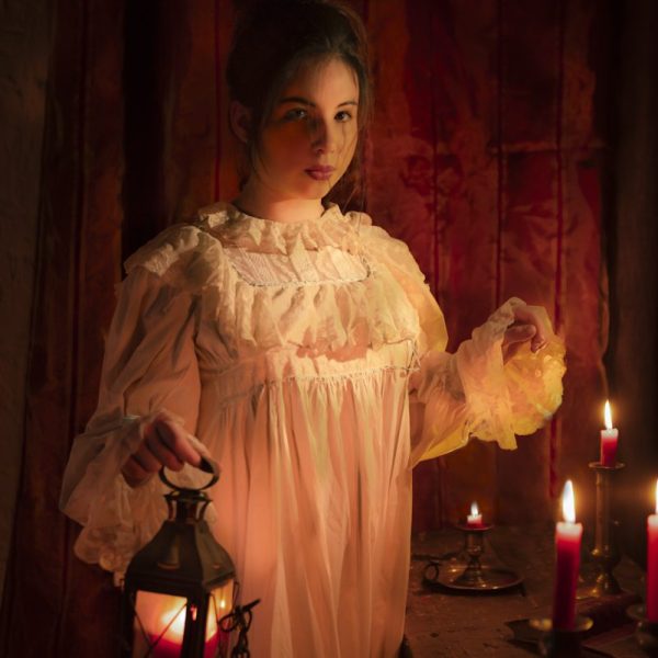 A detailed photo of a historically dressed woman in a nightgown holding a lantern - Fine Art Portraiture Workshop in Provence - Provence Lifestyle and Photography Tours