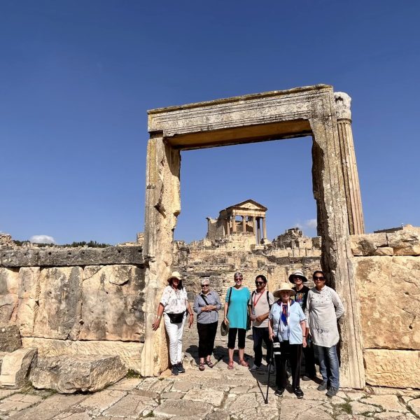 Group of women exploring the ancient Roman ruins of Dougga stop of the tour The Wonders of Tunisia