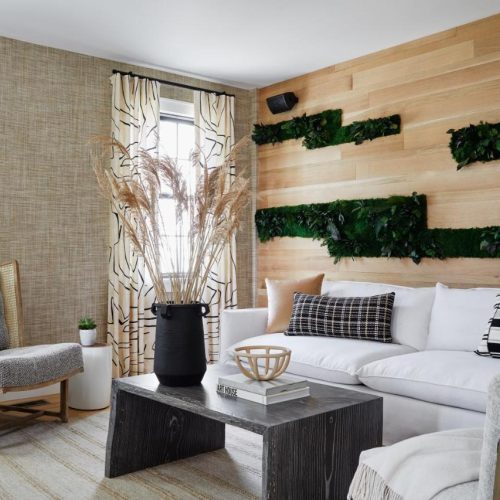 A cozy seating area and moss-art wall at the Edgartown Inn-Edgartown Collection by Lark Hotels in Martha's Vineyard, a safe place for women to stay