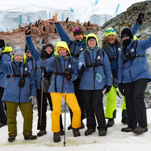 A group of tour participants standing amidst the stunning landscapes of the Falklands, South Georgia, and Antarctica.