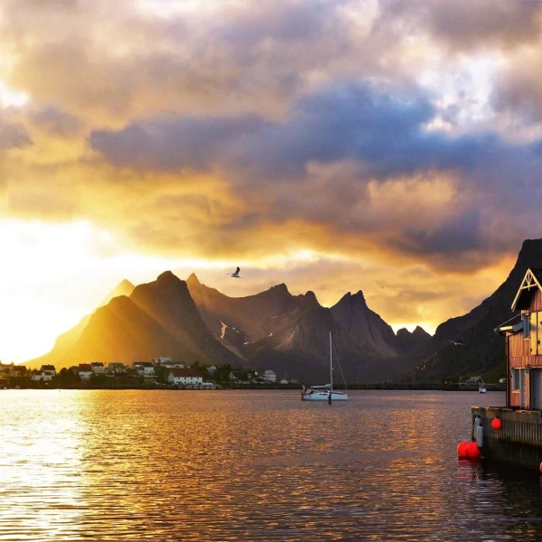 A picturesque sunset over Norwegian coastal cities, casting a warm glow over the tranquil waterfront.