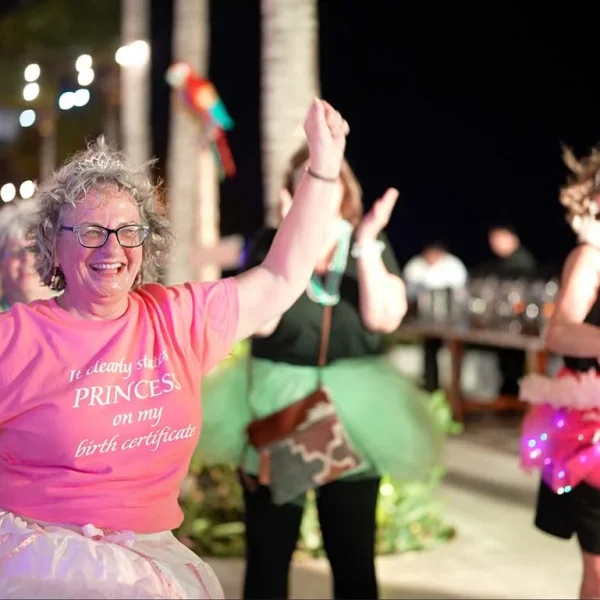 A group of women joyfully dancing at night during the Girlfriends Getaway 2024.