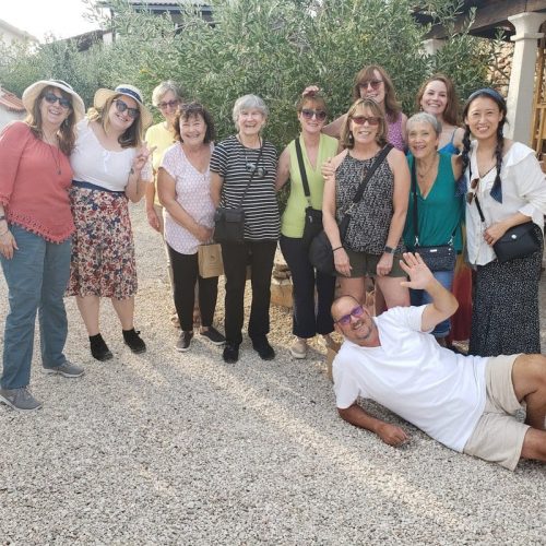 A Global Palate Adventures tour group pose for a photo with their beekeeper guide.