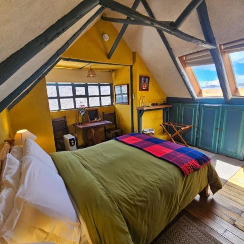 A beautiful, well-lit attic room with a view at the Hacienda el Porvenir by Tierra del Volcan in Machachi, Ecuador, and a safe place for women to stay