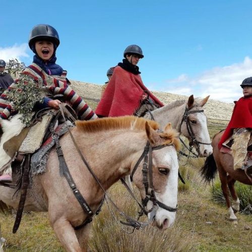 Young girls ride horseback dressed in ponchos on a stay at the Hacienda el Porvenir by Tierra del Volcan in Machachi, Ecuador, and a safe place for women to stay