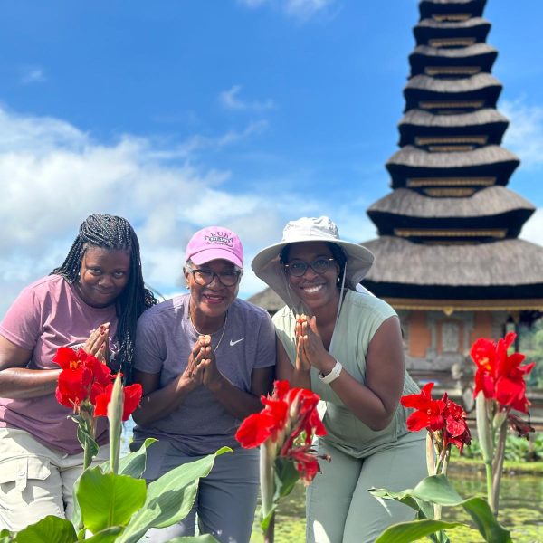 Tour participant posing for a photo outside a traditional Balinese temple - Bliss in Bali