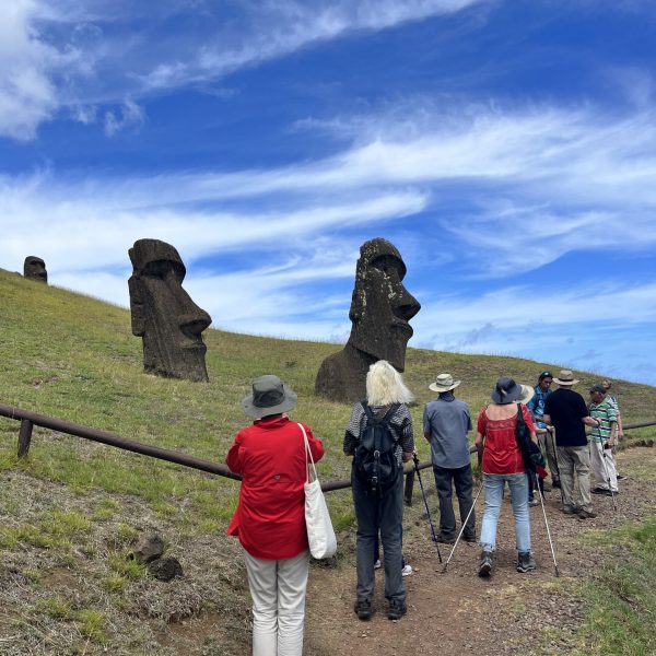 A group of women exploring the ancient moai statues and scenic landscapes of Easter Island on a guided tour.